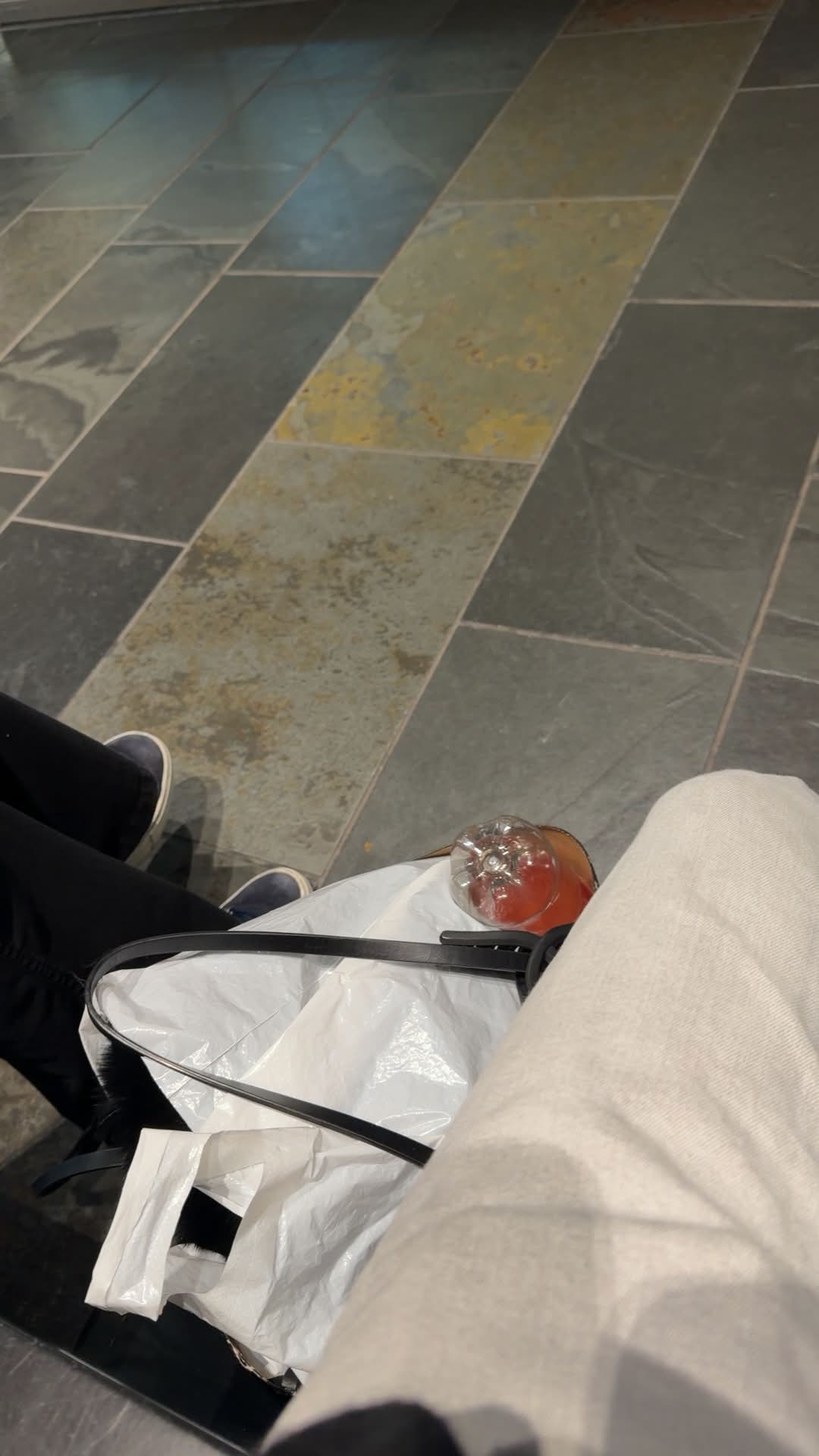 Two people sitting with a red drink