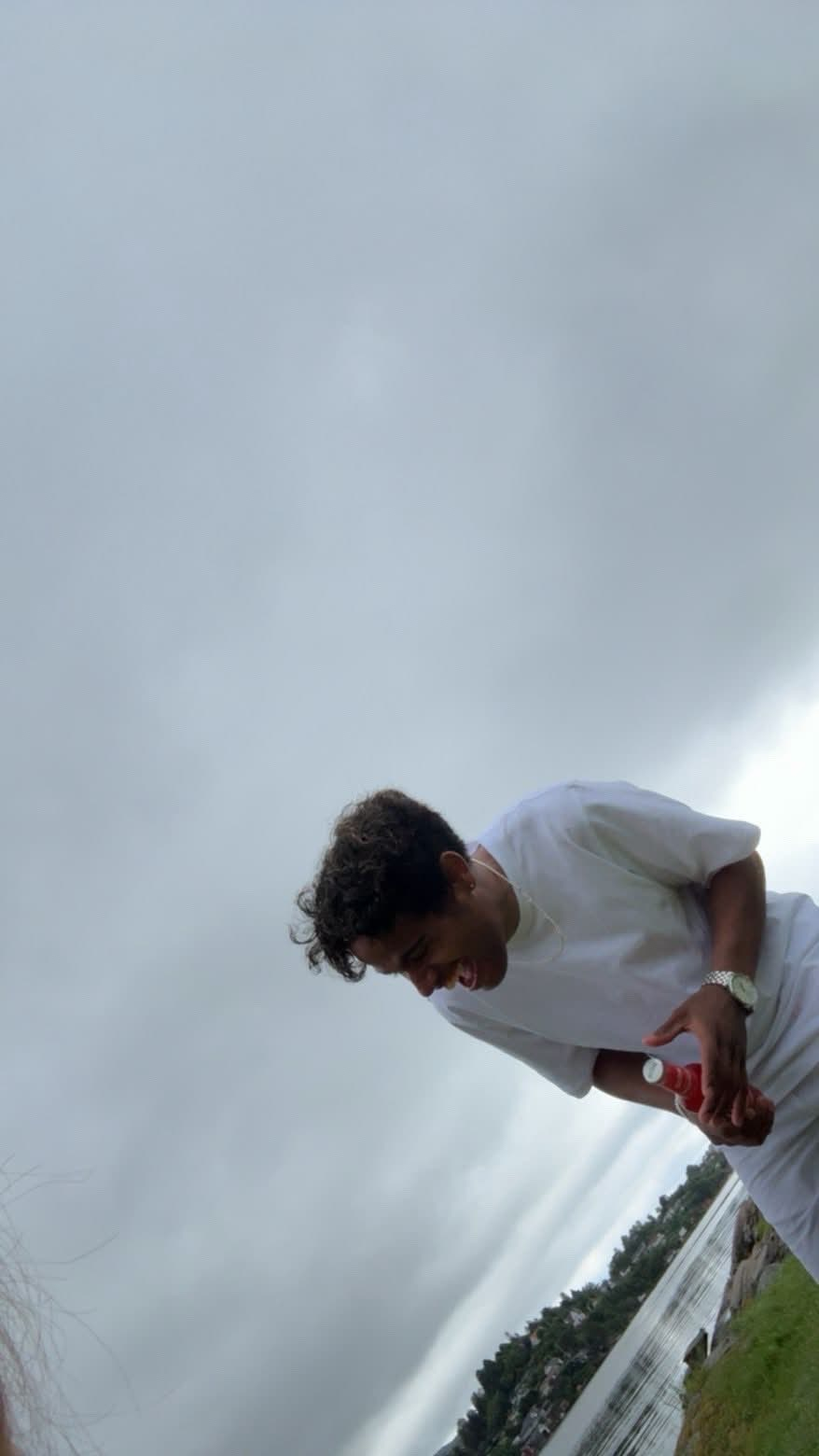 Friend holding a red drink outdoors